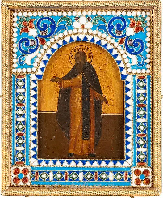 A SMALL ICON SHOWING A MONK WITH A SILVER-GILT...
