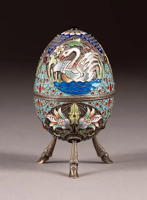 A SILVER AND CLOISONNÉ ENAMEL EGG ON STAND