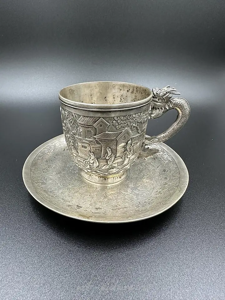 Chinese silver export cup with saucer, featuring a dragon handle and shield. 19th century.
