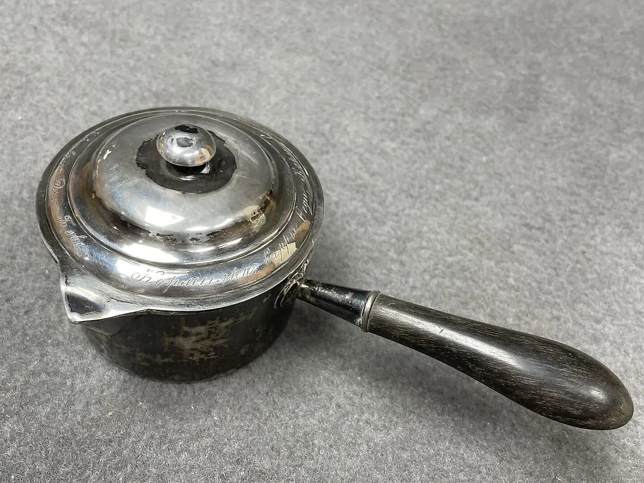 Silver ladle with a wooden handle that has been blackened. Marks... — photo 3