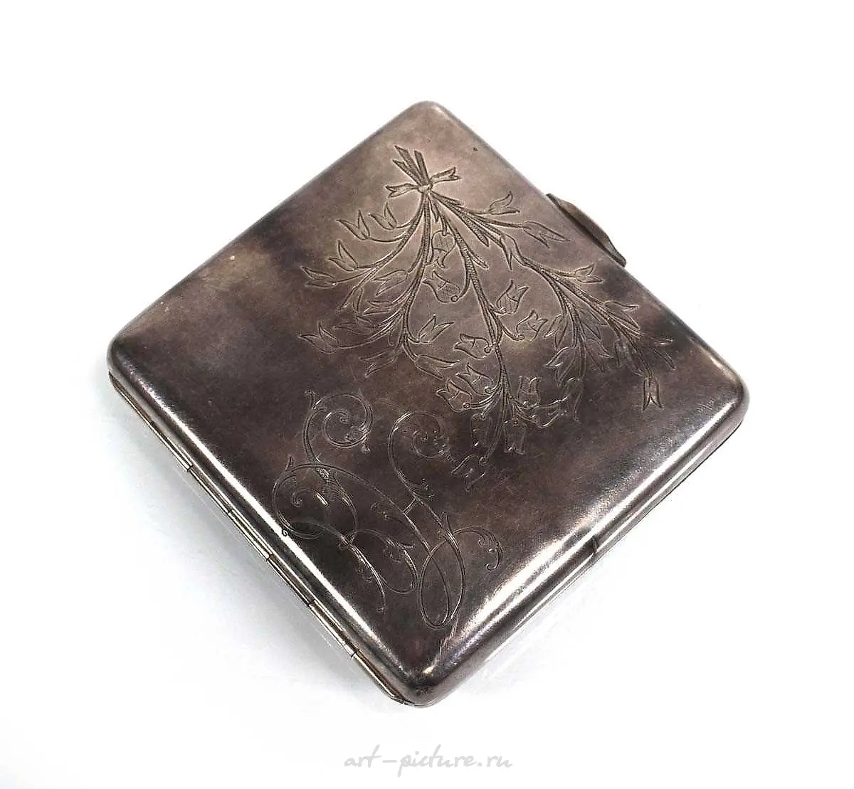 A silver and engine turned cigarette case of cushioned rectangular shape...