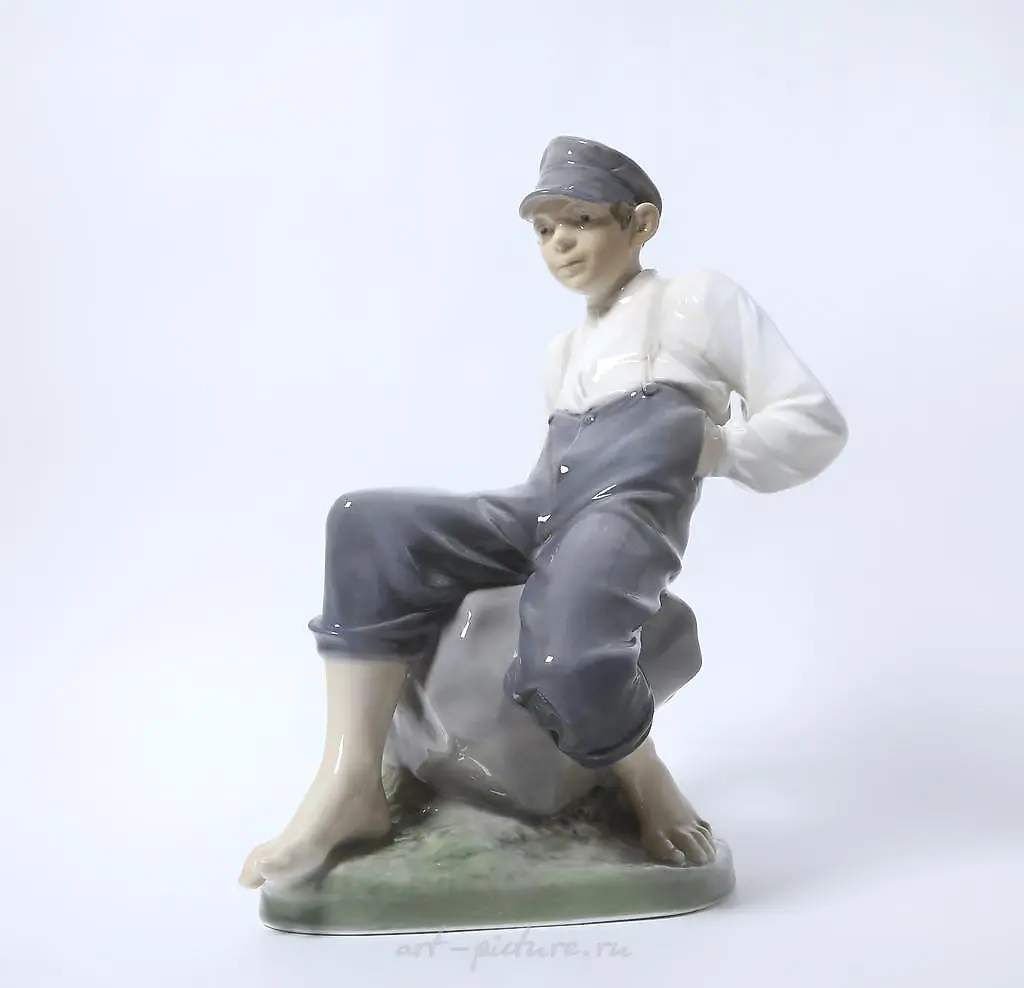 "Boy on a stone. Denmark, Copenhagen, Royal Copenhagen."