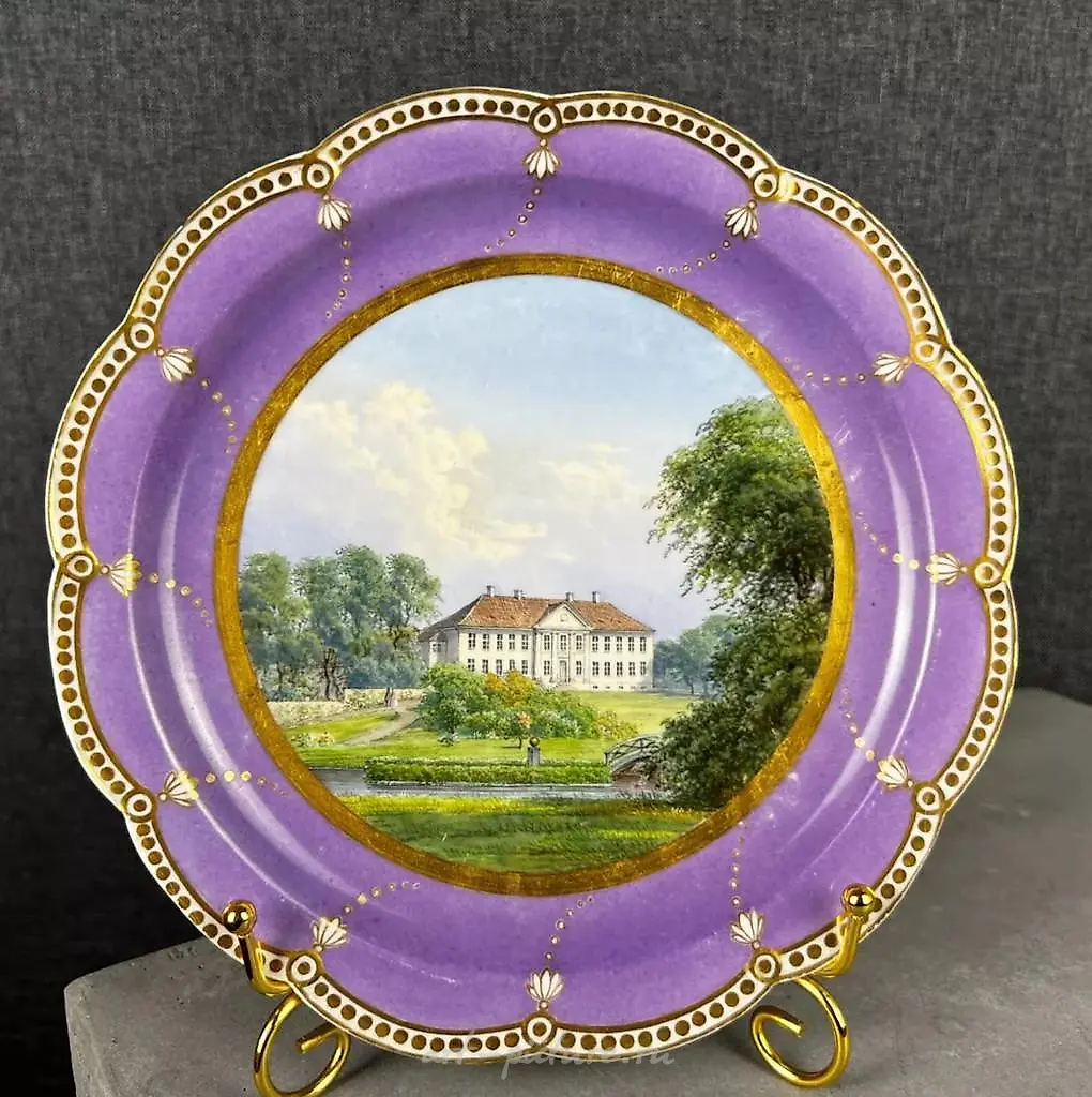 Topographic plate from Royal Copenhagen, featuring an image of a manor.
