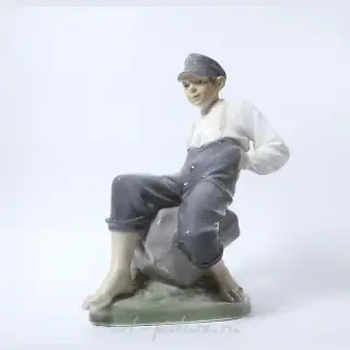 "Boy on a stone. Denmark, Copenhagen, Royal Copenhagen."