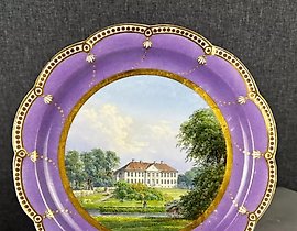 Topographic plate from Royal Copenhagen, featuring an image of a manor.