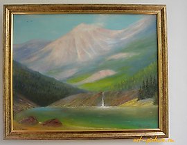 The translation of the text "Водопад в горах холст масло" into English is "Waterfall in the mountains, oil on canvas."