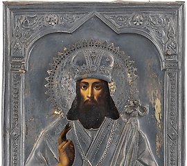 A SMALL ICON SHOWING ST. TIKHON OF SADONSK WITH A SILVER OK