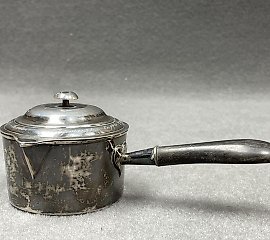 Silver ladle with a wooden handle that has been blackened. 
Marks...