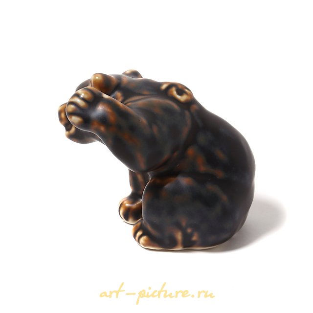 Bear cub with a raised paw. Denmark, Copenhagen, Royal Copenhagen.