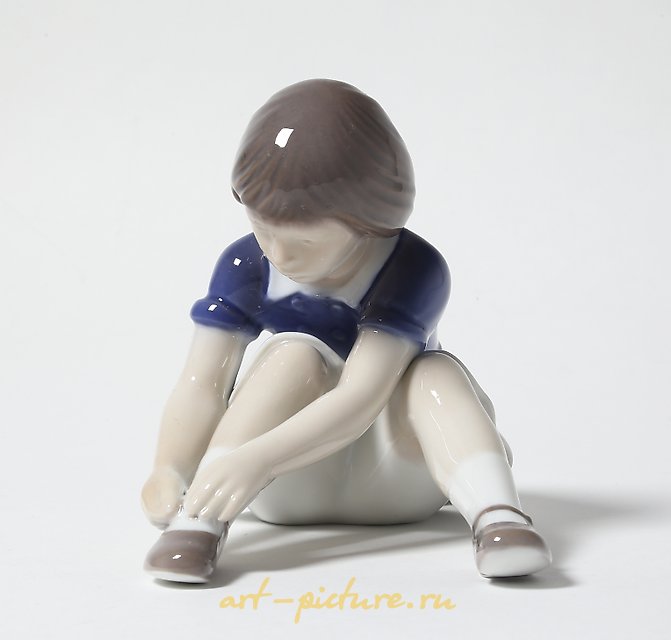 "Girl fastening her shoe. Denmark, Copenhagen, Bing & Grondahl."