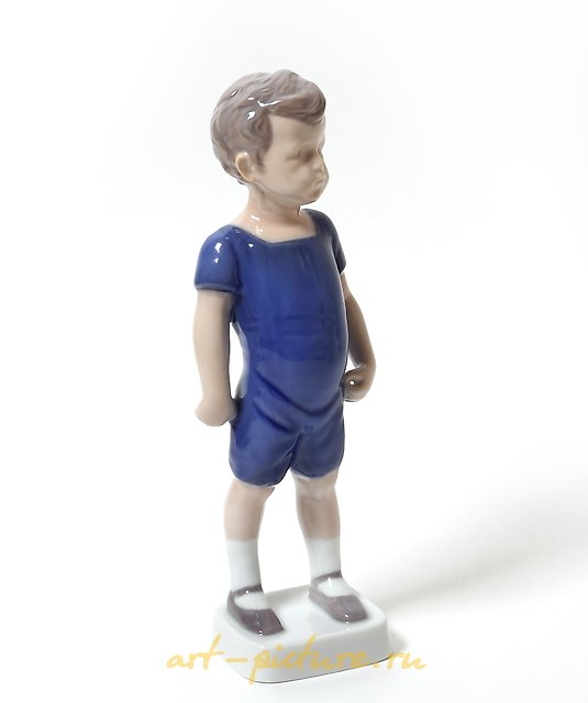 "Kai. A standing boy in shorts. Denmark, Copenhagen, Bing & Grondahl."