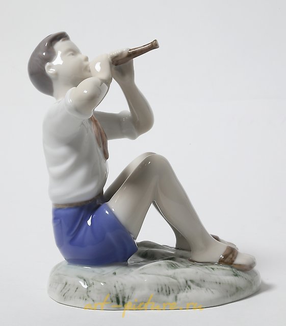 Porcelain figurine of a Boy Playing the Flute by Bing Grondahl.