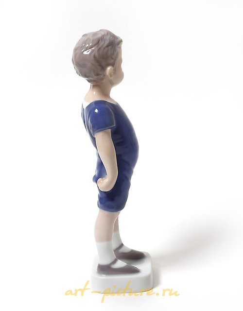 "Kai. A standing boy in shorts. Denmark, Copenhagen, Bing & Grondahl."