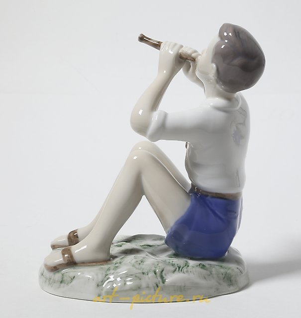 Porcelain figurine of a Boy Playing the Flute by Bing Grondahl.