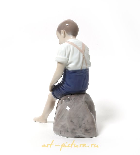 "Boy rolling up his pant leg. Denmark, Copenhagen, Bing & Grondahl."