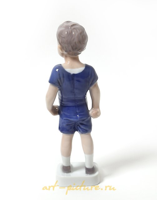"Kai. A standing boy in shorts. Denmark, Copenhagen, Bing & Grondahl."