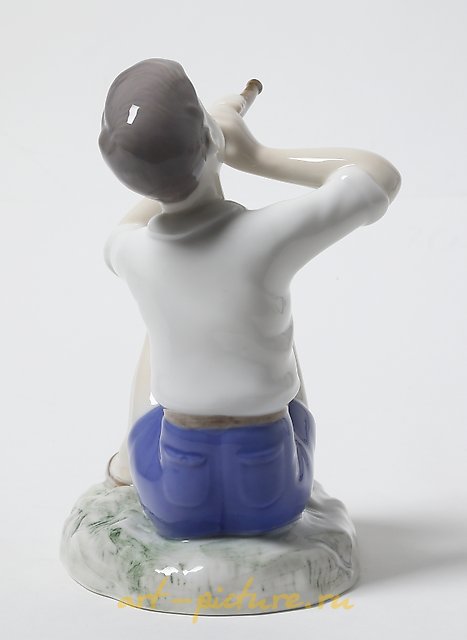 Porcelain figurine of a Boy Playing the Flute by Bing Grondahl.