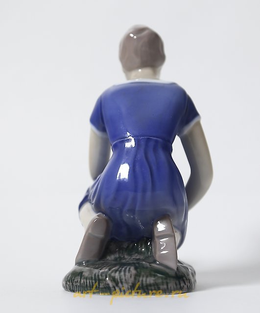 Porcelain figurine "Girl Planting Flowers" by Bing Grondahl.