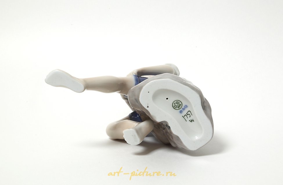 "Boy rolling up his pant leg. Denmark, Copenhagen, Bing & Grondahl."