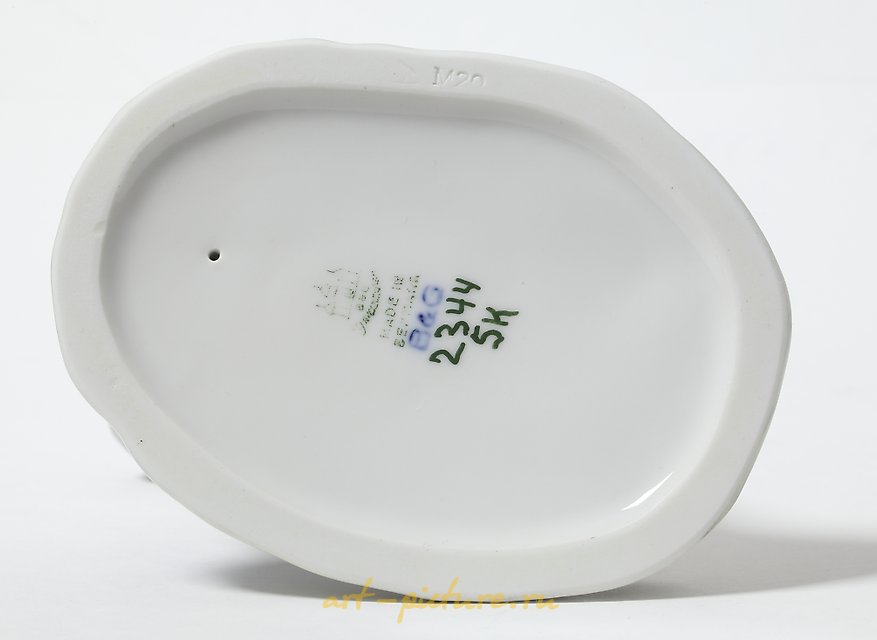 Porcelain figurine of a Boy Playing the Flute by Bing Grondahl.