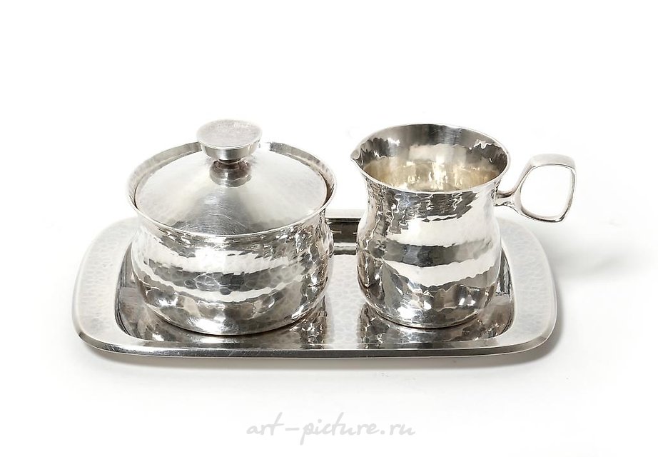 "Silver sugar bowl and creamer on a tray by Erik Lofman."