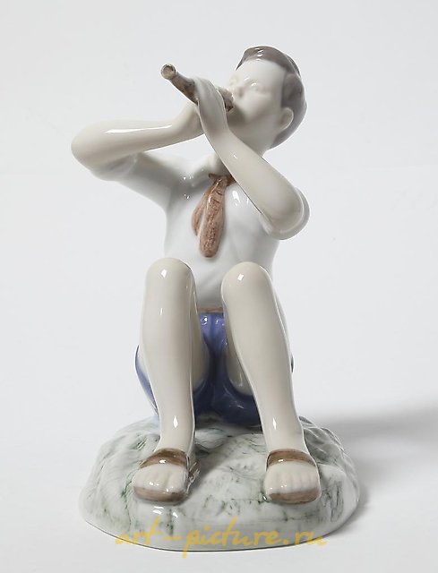Porcelain figurine of a Boy Playing the Flute by Bing Grondahl.