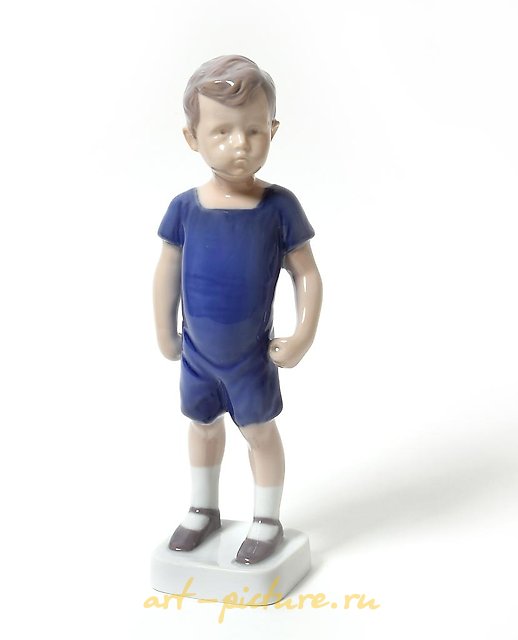 "Kai. A standing boy in shorts. Denmark, Copenhagen, Bing & Grondahl."