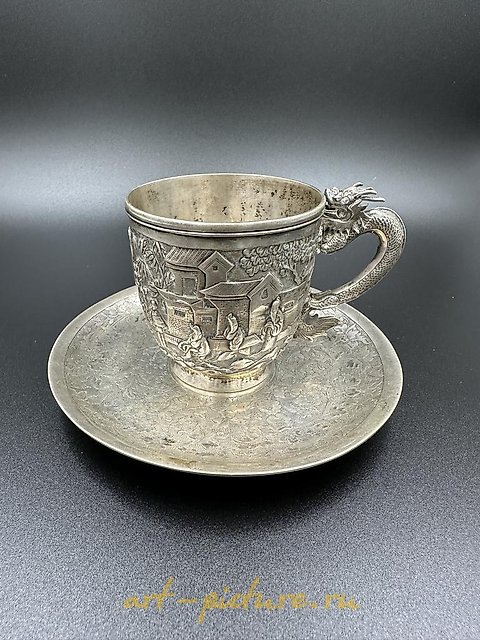 Chinese silver export cup with saucer, featuring a dragon handle and shield. 19th century.