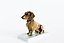 The figurine of a Dachshund on a pedestal by Porzellanfabrik Fraureuth AG Fraureuth, 1919.