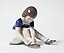 "Girl fastening her shoe. Denmark, Copenhagen, Bing & Grondahl."
