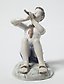 Porcelain figurine of a Boy Playing the Flute by Bing Grondahl.