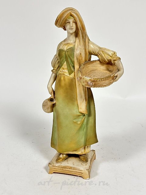 A Royal Dux Bohemia porcelain figure of a woman in tradition...