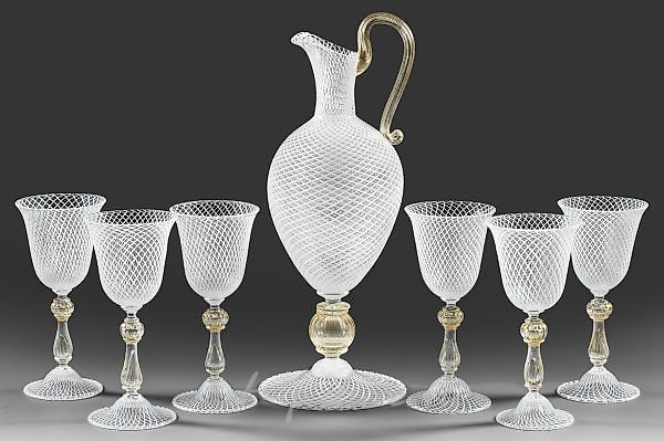 Decanter and six wine goblets with reticello decoration.