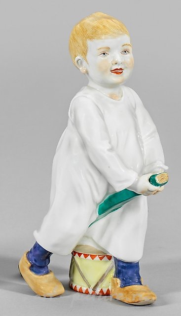 On a stick, a child is riding with a drum.