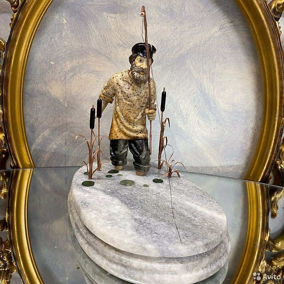Author's sculpture made of stone Fisherman from colored semi-precious stones.