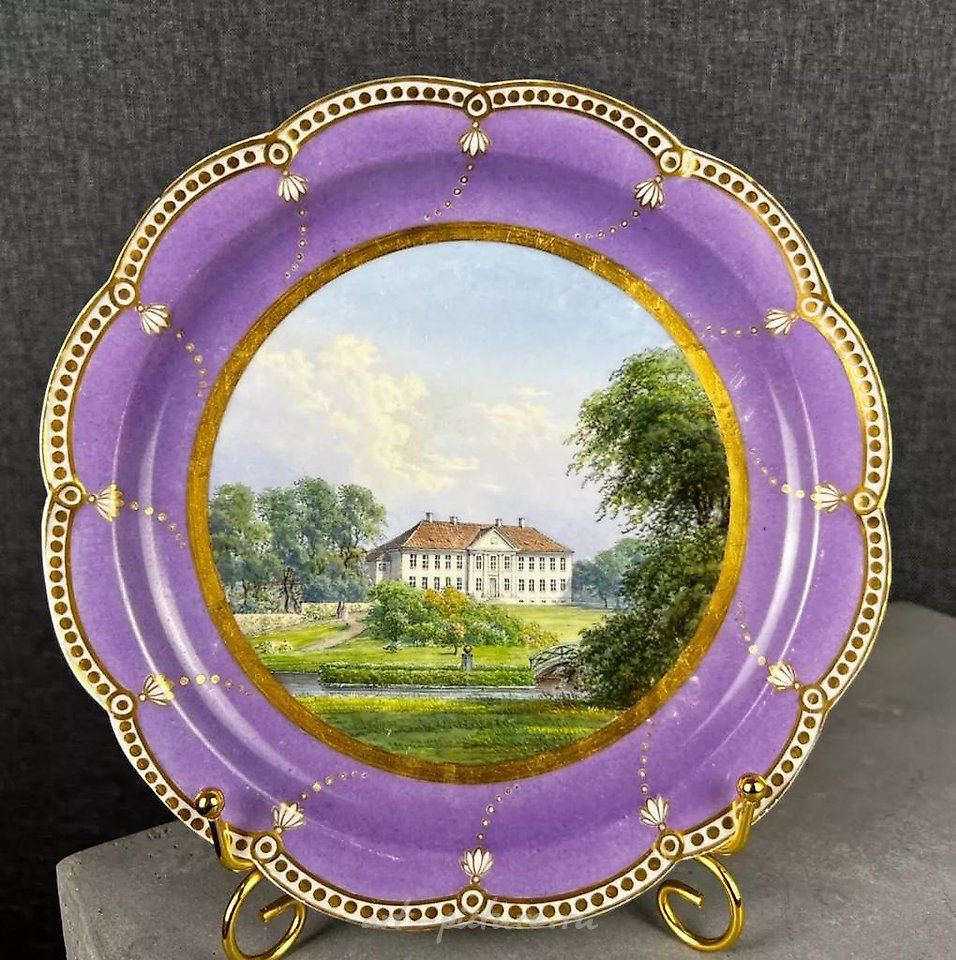 Topographic plate from Royal Copenhagen, featuring an image of a manor.