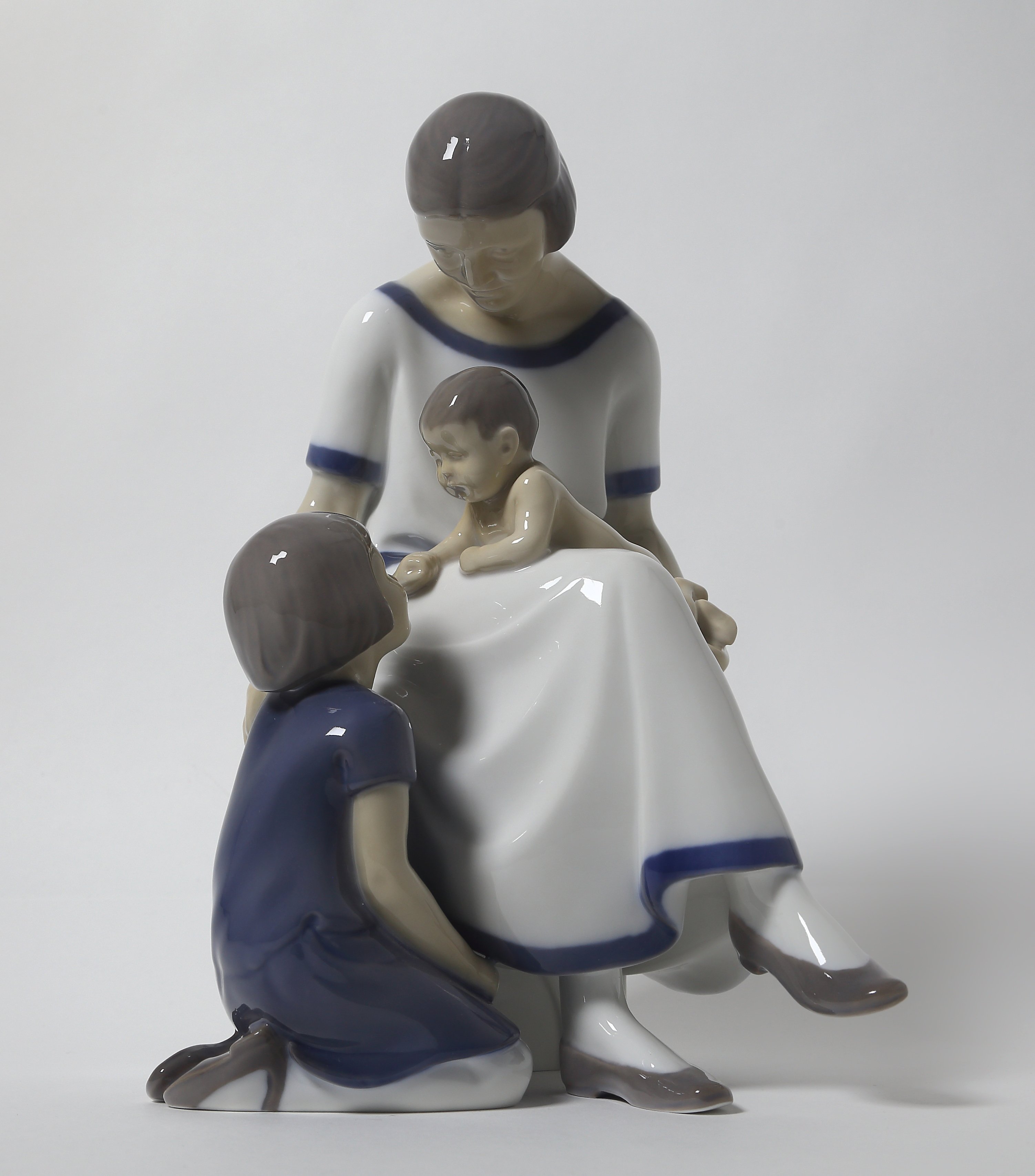 "Mother with two children. Denmark, Copenhagen, Bing & Grondahl."