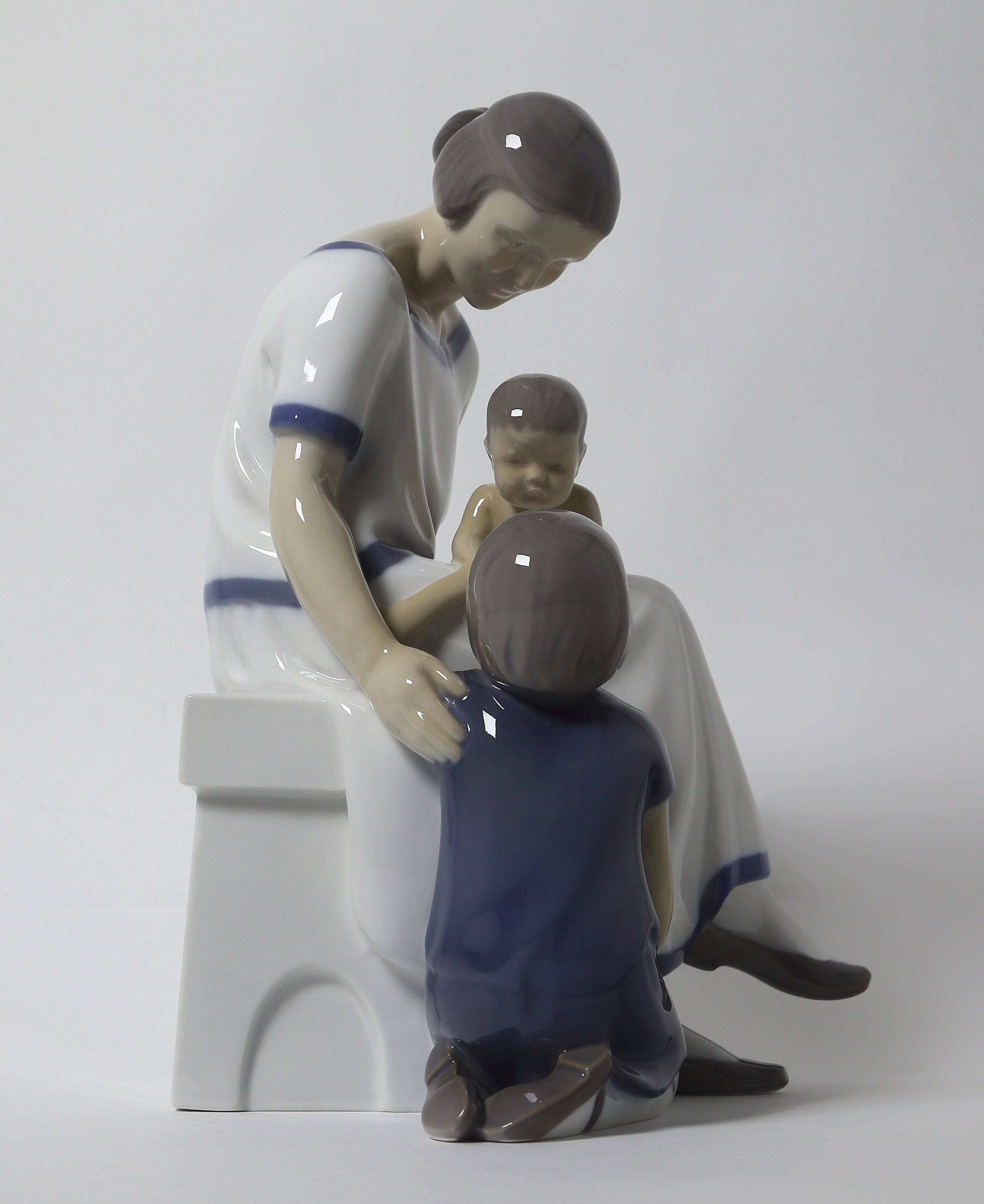 "Mother with two children. Denmark, Copenhagen, Bing & Grondahl."