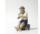 Porcelain figurine "Boy with a pipe".Dahl-Jensen.