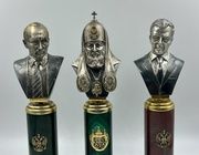 Silver busts of Putin V.V., Medvedev D.A., Patriarch Kirill on pedestals.