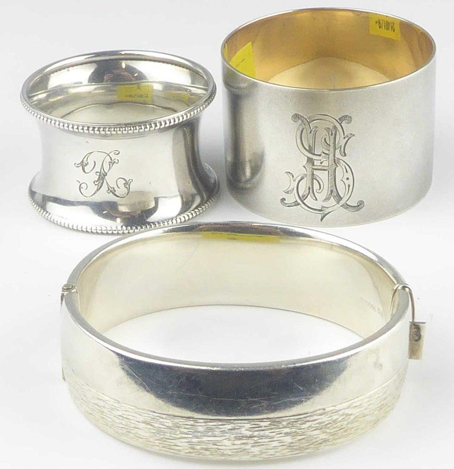 Russian silver , Seven various hallmarked silver napkin rings, to include a plain design, a floral pattern, a geometric pattern, a monogrammed design, a beaded design, a filigree design, and a hammered design.