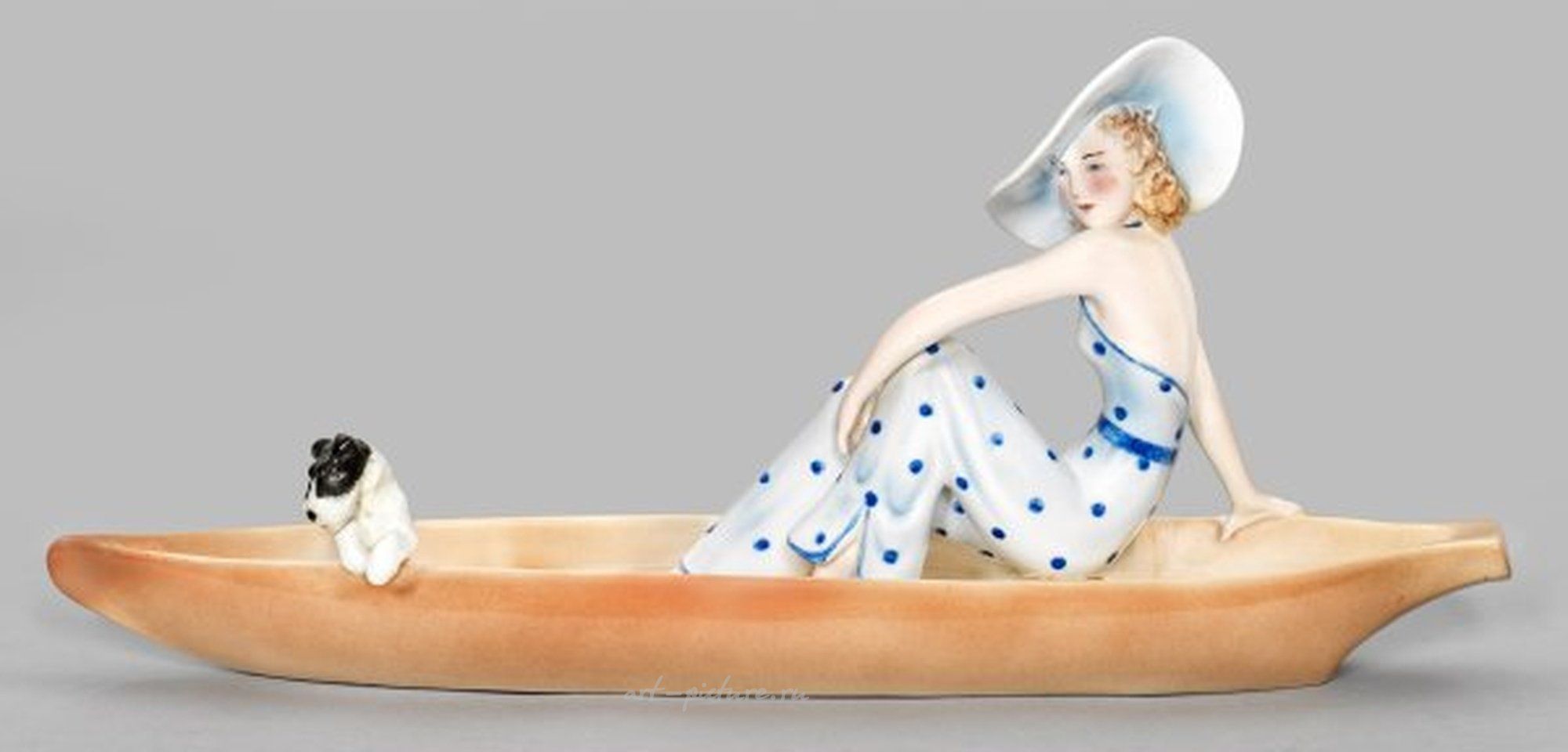 Goldschneider Figure - A fashionable lady with a fox terrier in a boat.