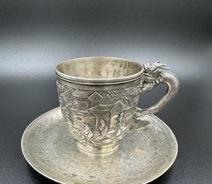 Chinese silver export mug with a saucer, a handle in the form of a dragon and a shield.19th century.