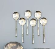 Russian-style silver and vermeil ice service with ornate spoons.